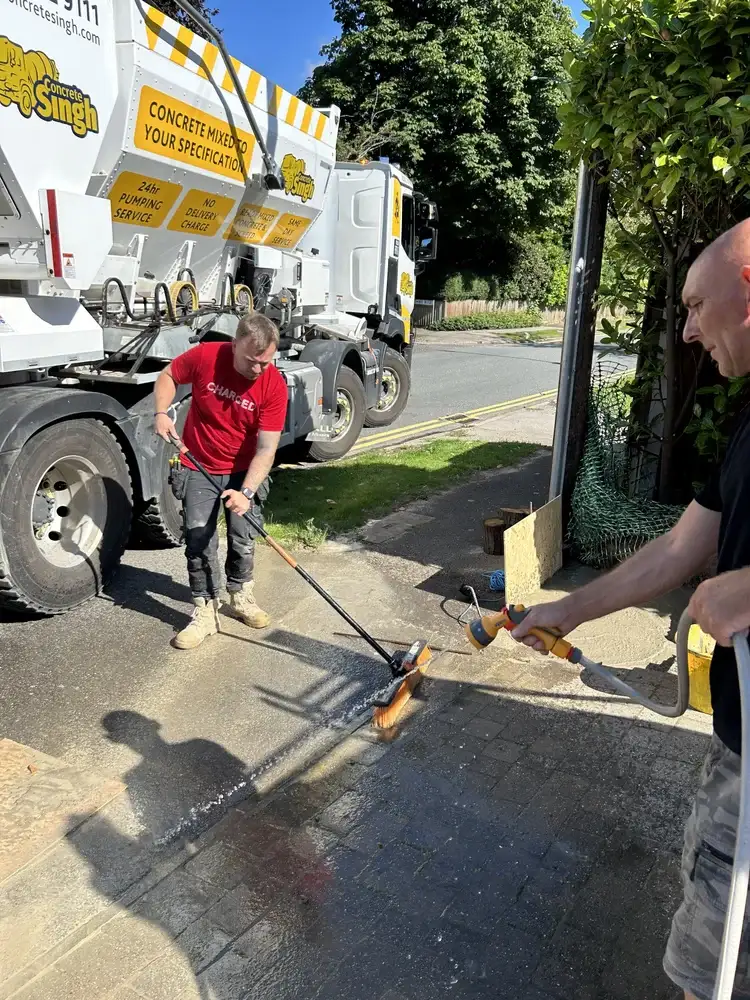 Washing down driveway after concrete delivery