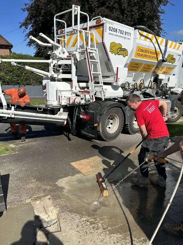 Washing down driveway after concrete delivery